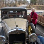 Dr. Denmark in George Bugg's car on her 110th birthday. Mary Hutcherson standing outside of car